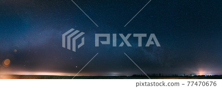 Night Starry Sky With Glowing Stars Above Countryside Landscape. Milky Way Galaxy And Rural Field Meadow In Early Spring. Panorama, Panoramic View 77470676