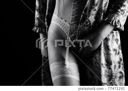 Black and white photo of the woman in silk negligee and stockings 77471291