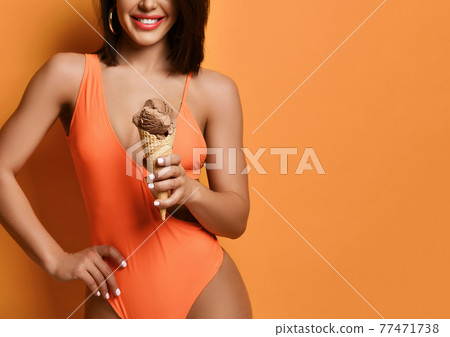 Woman hold chocolate ice-cream. Girl in sexy Woman hold chocolate ice-cream. Girl in sexy 77471738