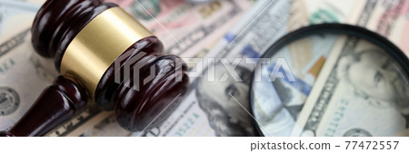 On table is magnifying glass calculator and a judge's hammer On table is magnifying glass calculator and a judge's hammer 77472557