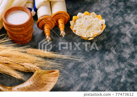 Jewish holiday Shavuot for kosher dairy food on torah scroll and tallis 77473612