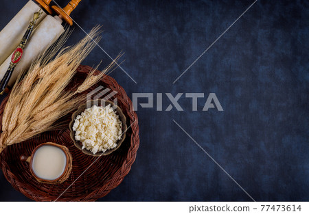 Symbols of jewish holiday Shavuot torah and shofar old red background. 77473614