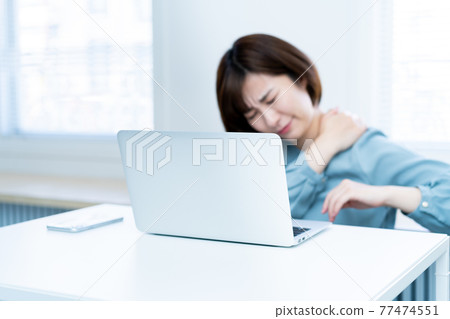 Young woman feeling tired from teleworking Young woman feeling tired from teleworking 77474551