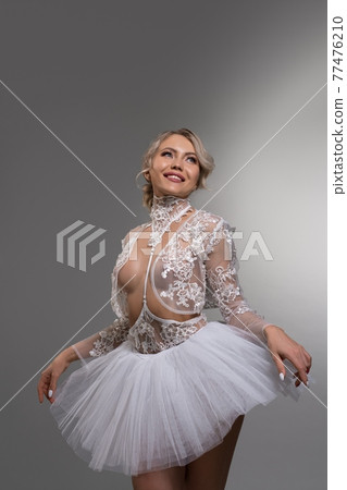 Sensual female ballet dancer touching tutu skirt 77476210