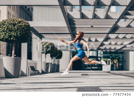Athlete woman in sportswear doing sport exercises 77477434