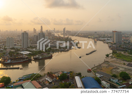 Aerial view of Bangkok City skyline by Chao Phraya River in Thailand. Financial district and skyscraper office buildings. Downtown skyline. Urban town at sunset. 77477754