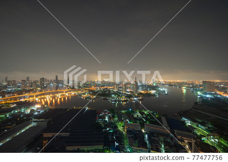 Aerial view of Bangkok City skyline by Chao Phraya River in Thailand. Financial district and skyscraper office buildings. Downtown skyline. Urban town at night. 77477756