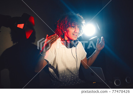 Closeup portrait of confident DJ with headphones Closeup portrait of confident DJ with headphones 77478426