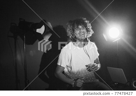 Closeup portrait of confident DJ with headphones Closeup portrait of confident DJ with headphones 77478427