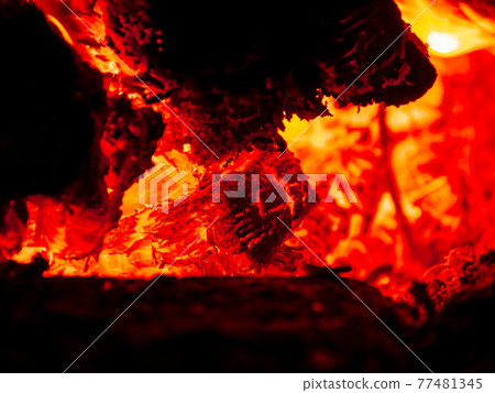 Burning firewood in rural oven. Red flame of wood stove in the dark. Cozy warm fireplace bonfire combustion at night. Burning firewood in rural oven. Red flame of wood stove in the dark. Cozy warm fireplace bonfire combustion at night. 77481345