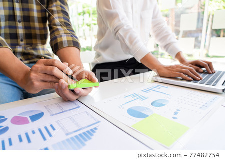 business man financial inspector and secretary making report and brainstorming with colleague in a modern co-working space 77482754