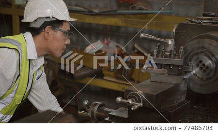 professional mechanical engineer or operation man wear uniform goggles safety working on workshop metal lathe industrial professional mechanical engineer or operation man wear uniform goggles safety working on workshop metal lathe industrial 77486703