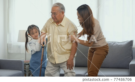 Daughter and granddaughter take care support grandfather who is suffering from knee pain Got walking Daughter and granddaughter take care support grandfather who is suffering from knee pain Got walking 77486706