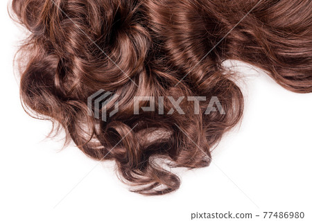Brown hair texture. Wavy long curly light brown hair close up isolated on white. Hair extensions, materials and cosmetics, hair care, wig. Hairstyle, haircut or dying in salon Brown hair texture. Wavy long curly light brown hair close up isolated on white. Hair extensions, materials and cosmetics, hair care, wig. Hairstyle, haircut or dying in salon 77486980
