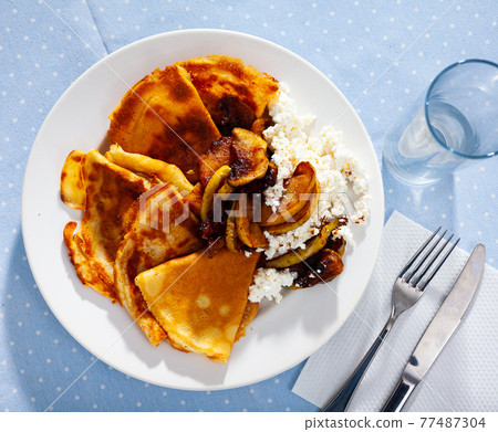 Sweet crepes with cottage cheese and baked apples with cinnamon Sweet crepes with cottage cheese and baked apples with cinnamon 77487304