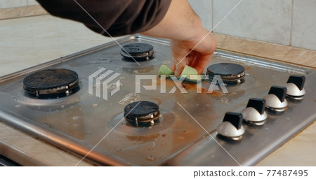 Dirty stove in a kitchen cleaned 77487495