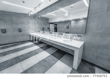 White sinks by the mirror in the toilet. White sinks by the mirror in the toilet. 77488701