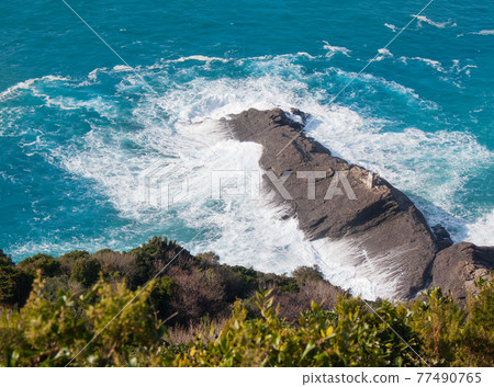 Punta Chiappa rocky cape hit by powerful waves Punta Chiappa rocky cape hit by powerful waves 77490765