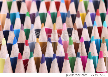 Many sharp multicolored wooden pencils closeup background 77491532