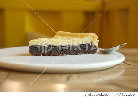 half eaten a slice of cheese cake  77492199