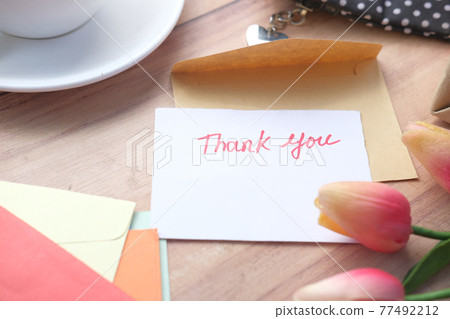 thank you message, flower and envelope on wooden table thank you message, flower and envelope on wooden table 77492212