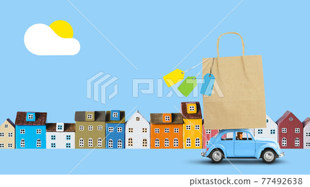 Blue car with shopping paper bag on the roof Blue car with shopping paper bag on the roof 77492638