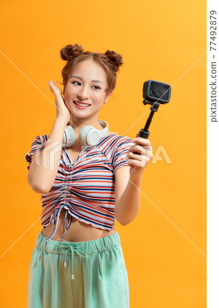 Pretty thai woman taking selfie with action camera 77492879