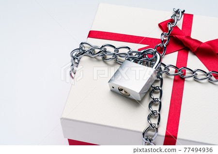 Padlock chained to a gift box 77494936