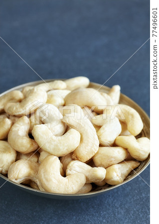 Cashew nuts in a bowl, selective focus, space for text. 77496601