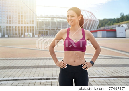 Smiling beautiful lady going for a run in the city Smiling beautiful lady going for a run in the city 77497171