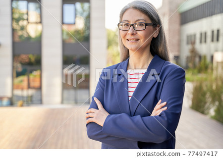 Professional lady in classy outfit posing for the camera 77497417