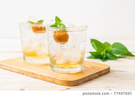 iced plum juice with soda and peppermint 77497895