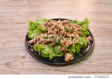 Thai spicy chop chicken salad and fresh vegetable on plate 77498537