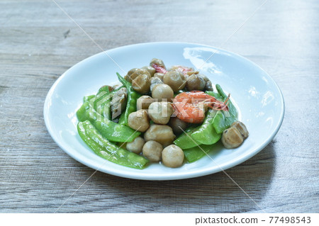stir fried green pea and straw mushroom with shrimp couple pork in soybean sauce on plate 77498543