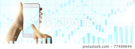 Close-up Of Business man's hand holding smartphone showing stock market statistics gain profits and increase of chart positive indicators. Financial analysis, statistics. Concept of business strategy. 77499644