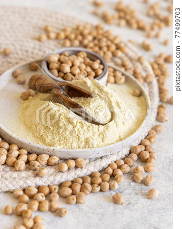 Plate of raw chickpea flour and beans Plate of raw chickpea flour and beans 77499703