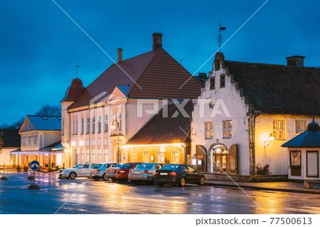 Kuressaare, Estonia. Old Gross Weight Storage Building House Near Market In Tallinna Street At Evening Night. Street In Fesive Christmas Xmas New Year Illuminations. Kuressaare, Estonia. Old Gross Weight Storage Building House Near Market In Tallinna Street At Evening Night. Street In Fesive Christmas Xmas New Year Illuminations. 77500613