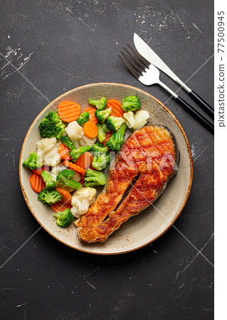 Grilled salmon steak with vegetables salad from above Grilled salmon steak with vegetables salad from above 77500945