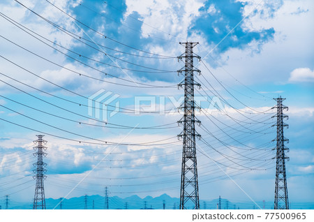 Lined power transmission towers and clouds floating in the sky Far mountains vivid Lined power transmission towers and clouds floating in the sky Far mountains vivid 77500965