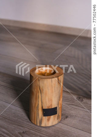 Wooden candle holder rustic interior centerpiece with candles in a cozy barn setting. Wooden candle holder rustic interior centerpiece with candles in a cozy barn setting. 77502446