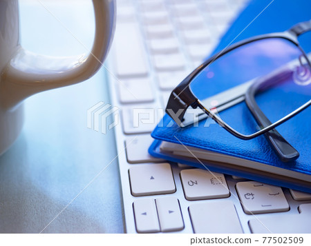 Business image · notebook · glasses · keyboard 77502509