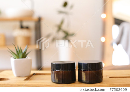 Man's cosmetics for hair in the glass bottle on neutral background Man's cosmetics for hair in the glass bottle on neutral background 77502609