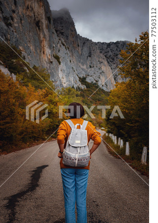 Outdoor fashion photo of young beautiful lady surrounded autumn forest in mountains Outdoor fashion photo of young beautiful lady surrounded autumn forest in mountains 77503112
