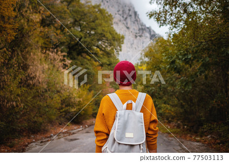 Outdoor fashion photo of young beautiful lady surrounded autumn forest in mountains Outdoor fashion photo of young beautiful lady surrounded autumn forest in mountains 77503113