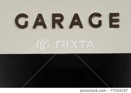 GARAGE written in capital letters on a white wall GARAGE written in capital letters on a white wall 77504297