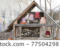 Wooden house for insects and bees with cones and flowerpots 77504298