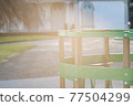 Turning carousel game on a children playground with sunlight flare 77504299