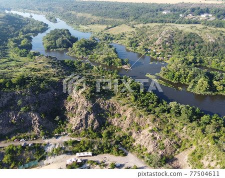 Winding bed of the Southern Bug river. River, landscape from a bird's eye view. Rough, rocky terrain. Winding bed of the Southern Bug river. River, landscape from a bird's eye view. Rough, rocky terrain. 77504611