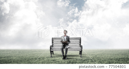 Young businessman or student studying the science in summer park Young businessman or student studying the science in summer park 77504801