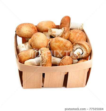 champignons in a wicker basket isolated on a white background. 77505084